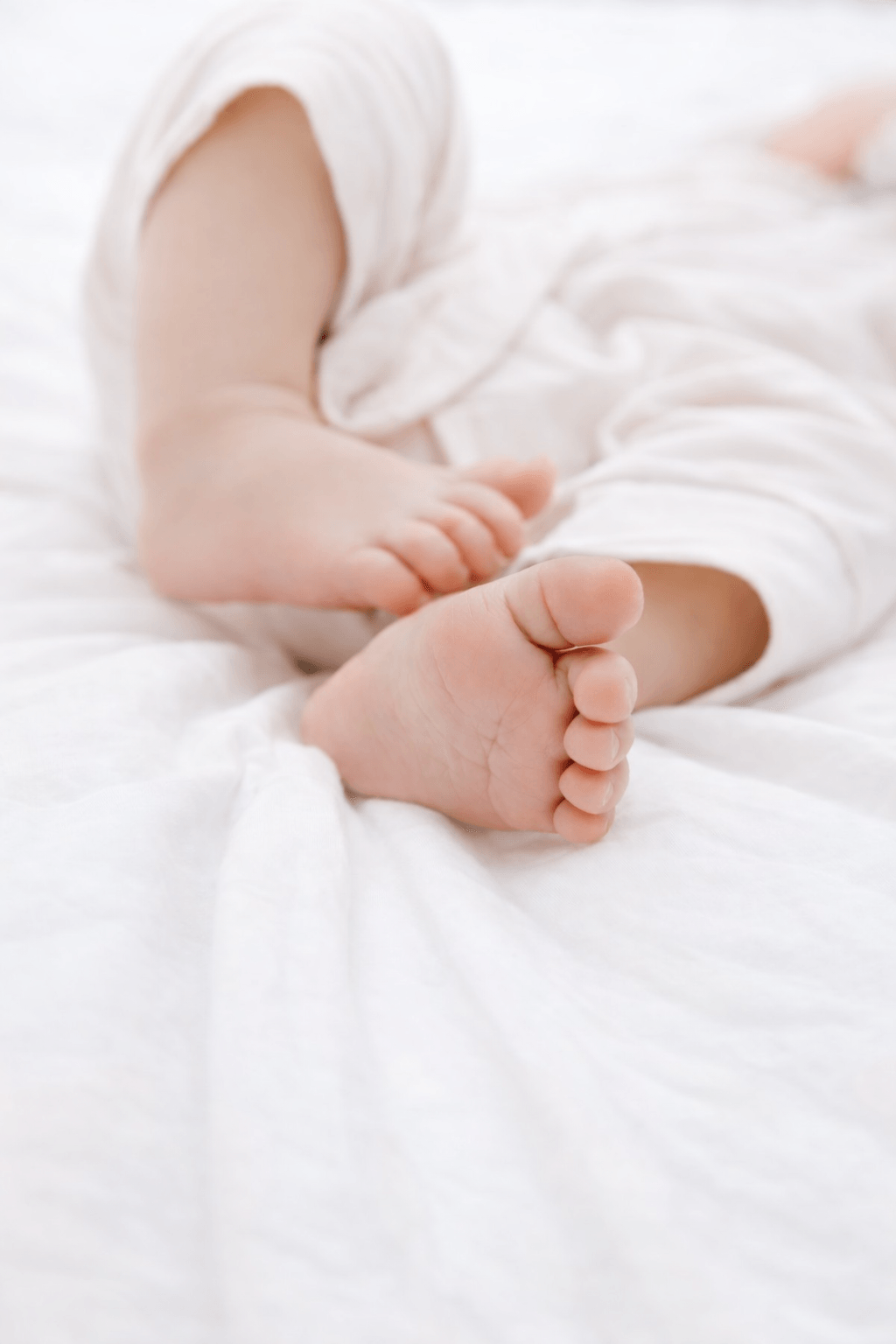 Newborn baby feet cradled in a parent’s hands at Palm Beach Fertility Center in South Florida